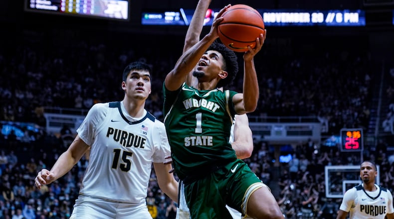 Wright State guard Trey Calvin (1) shoots in front of Purdue center Zach Edey (15) during the first half of an NCAA college basketball game in West Lafayette, Ind., Tuesday, Nov. 16, 2021. (AP Photo/Michael Conroy)