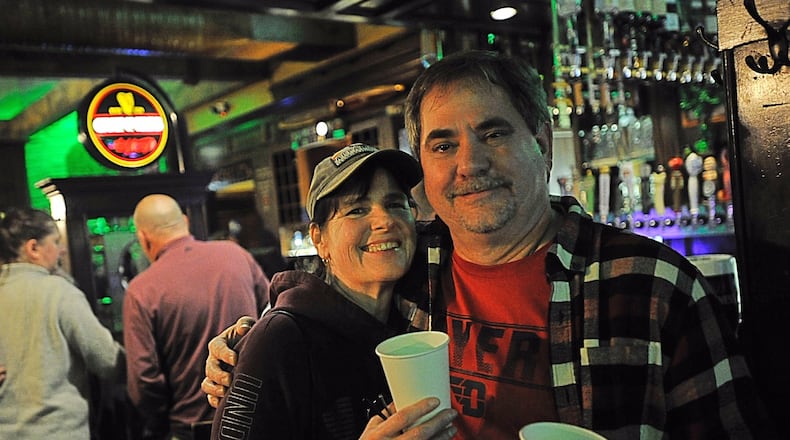 Jeff and Lori Law celebrated the early closing Sunday at the Dublin Pud by buying a round of shots for everyone inside. Gov. Mike DeWine ordered all bars and restaurants be closed at 9 o’clock Sunday to any customers eating or drinking inside the establishments. Delivery and take-out service remains an option. MARSHALL GORBYSTAFF