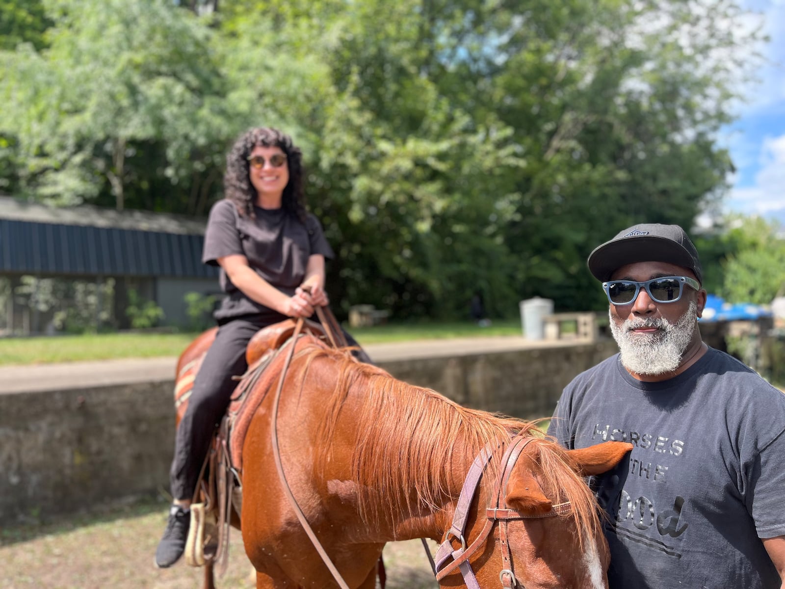 Writer Hannah Kasper rides a horse at the Dayton Urban Riding Center with owner Channey Goode at the reigns. CONTRIBUTED