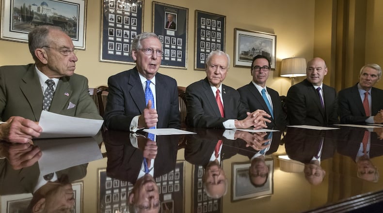 From left, Senate Judiciary Committee Chairman Chuck Grassley, R-Iowa, Senate Majority Leader Mitch McConnell, R-Ky., Senate Finance Committee Chairman Orrin Hatch, R-Utah, Treasury Secretary Steven Mnuchin, President Donald Trump’s top economic adviser Gary Cohn, and Sen. Rob Portman, R-Ohio, speak at a news conference as work gets underway on the Senate’s version of the GOP tax reform bill, on Capitol Hill in Washington, Thursday, Nov. 9, 2017. (AP Photo/J. Scott Applewhite)