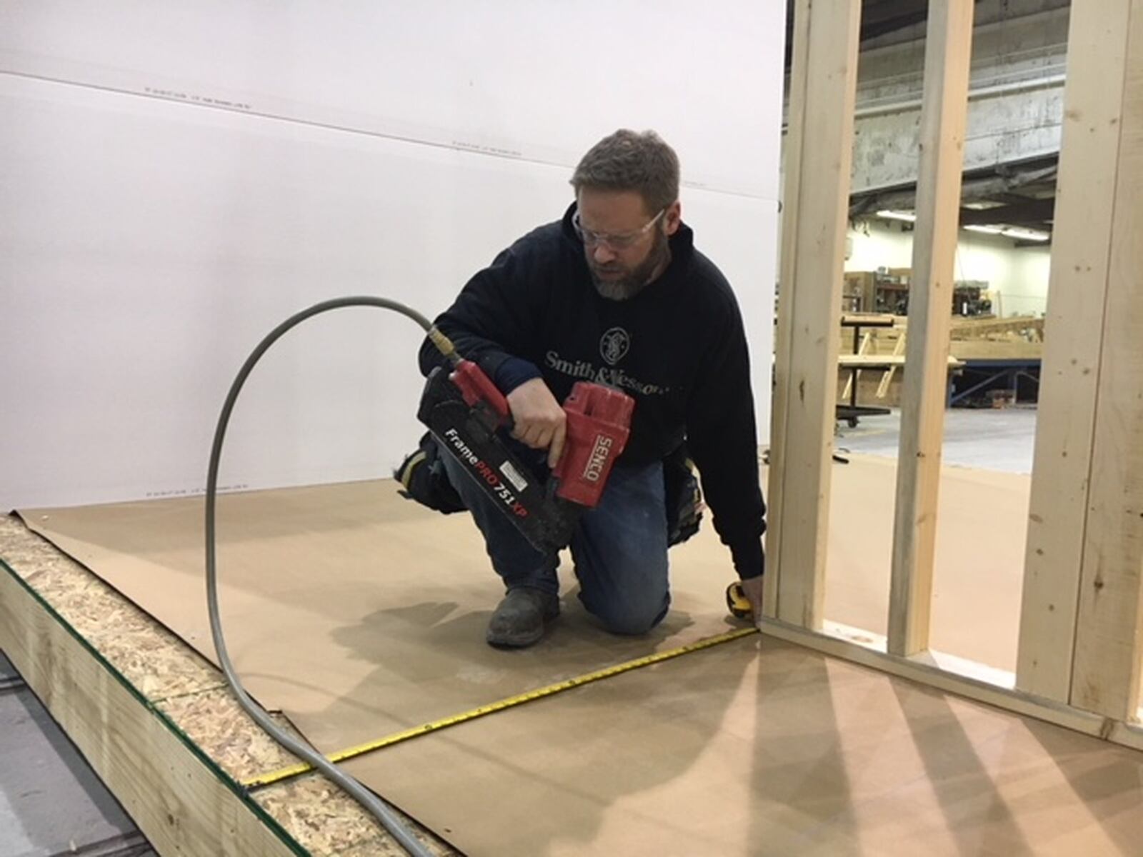 Tim Scarpelli, a framer at Unibilt, measures as he sets a wall on what will be someone’s new home. THOMAS GNAU/STAFF