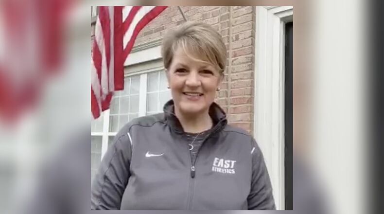 Lakota East High School Principal Suzanna Davis starts each school morning broadcasting from in front of her home as she recites the American pledge of allegiance to a flag her front door. Her social media messages, which also include school announcements and encouragement for students learning remotely and watching online, are part of a area trend of school officials broadcasting to keep student morale high during the coronavirus shutdown.(Provide Photo/Journal-News)