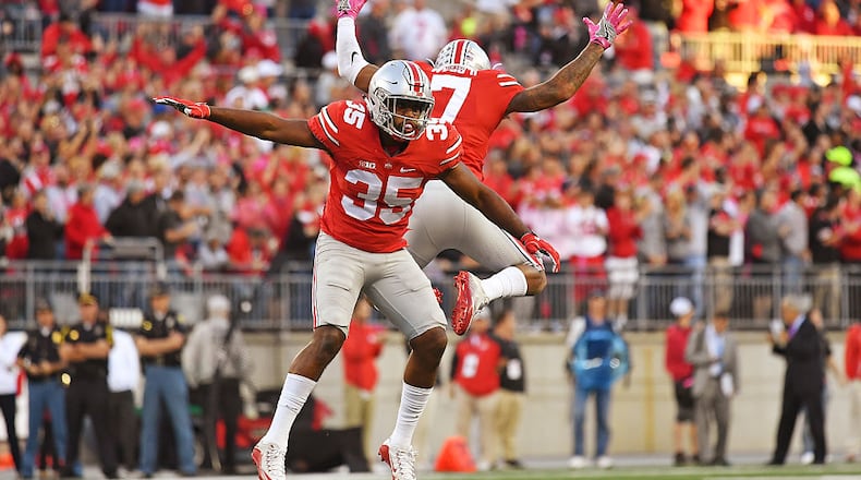 COLUMBUS, OH - OCTOBER 8: Chris Worley #35 of the Ohio State Buckeyes and Damon Webb #7 of the Ohio State Buckeyes celebrate after stopping the Indiana Hoosiers on fourth down near the goal line in the fourth quarter at Ohio Stadium on October 8, 2016 in Columbus, Ohio. Ohio State defeated Indiana 38-17. (Photo by Jamie Sabau/Getty Images)