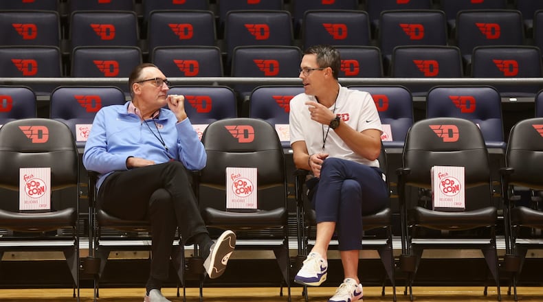 Former Flyers Jim Paxson, left, and Keith Waleskowski talk before an exhibition game against Bowling Green on Monday, Oct. 27, 2025, at UD Arena. David Jablonski/Staff