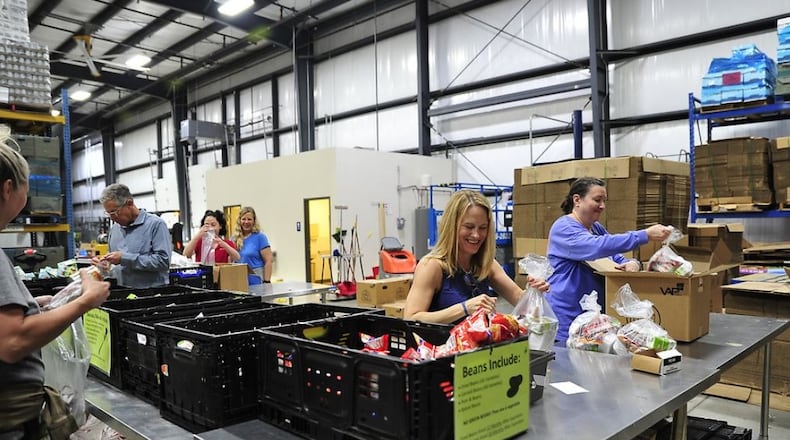 The Foodbank volunteers put together Good to Go backpacks for children. CONTRIBUTED