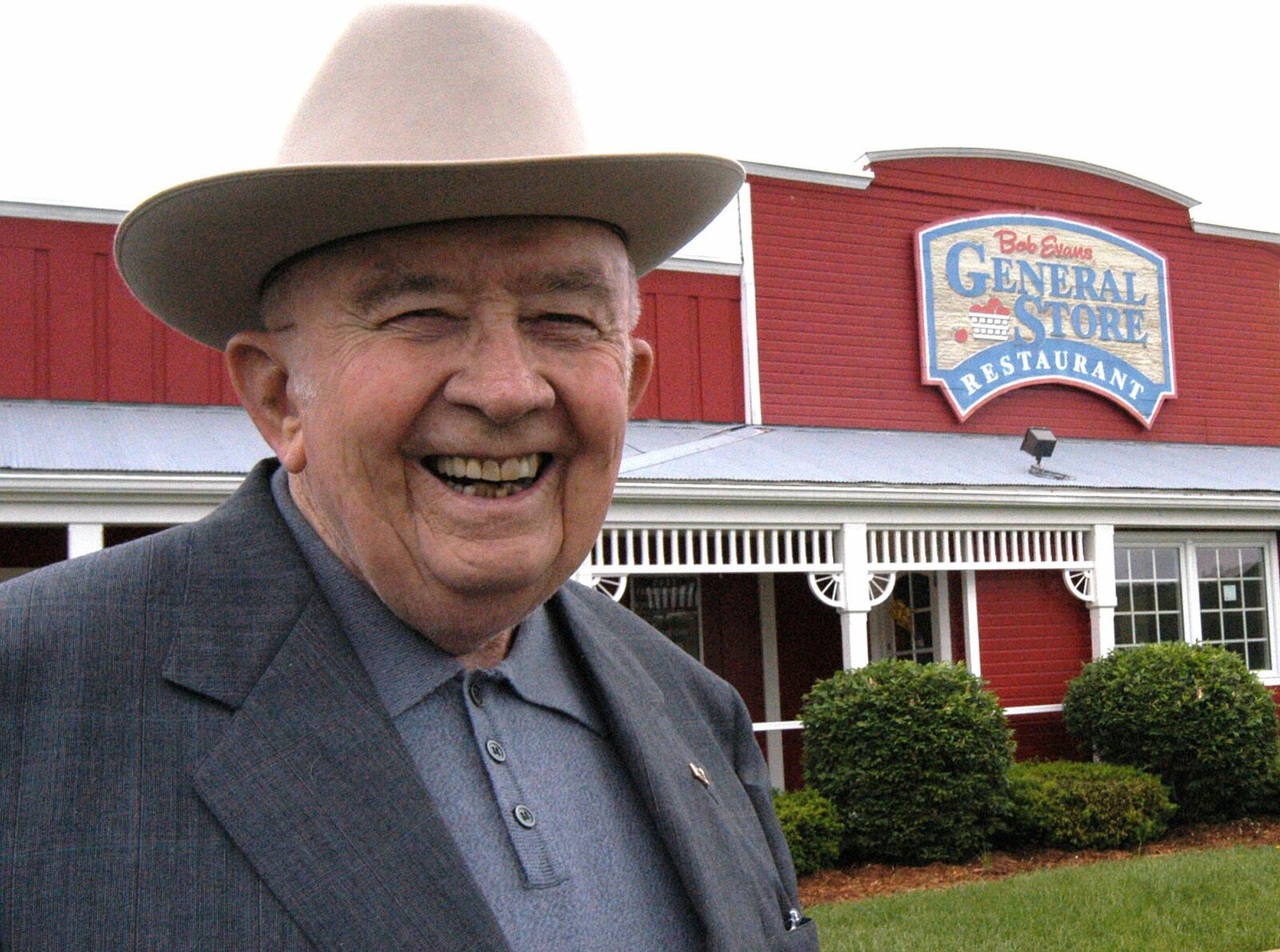 ** FILE ** In this May 6, 2003 file photo, Bob Evans poses for a photo in front of his restaurant in Rio Grande, Ohio. Evans, whose quest for quality sausage to serve the truckers who filled his 12-stool, 24-hour-a-day steakhouse in southeast Ohio led to the creation of a restaurant chain that bears his name, died Thursday, June 21, 2007, Bob Evans Farms Inc. said. He was 89. (AP Photo/Terry Gilliam, file)