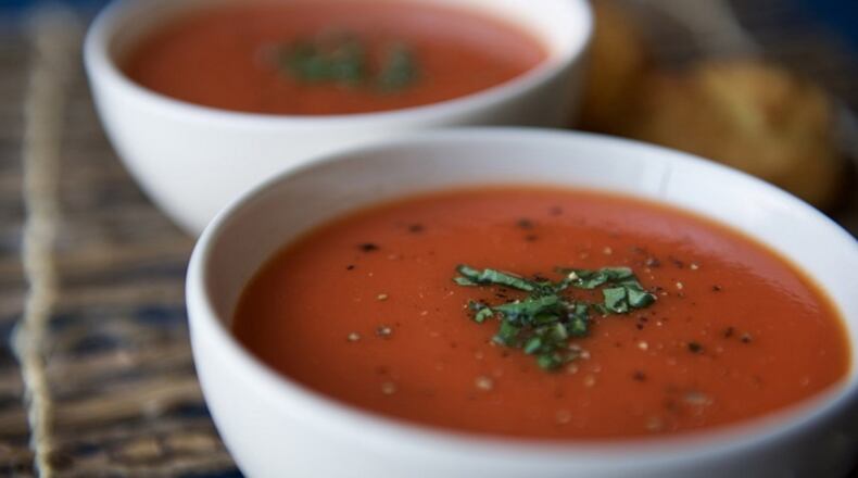 Chilled fresh tomato soup garnished with basil, salt and pepper is paired with drop biscuits and prepared for two. (Morgan Timms/St. Louis Post-Dispath/TNS)