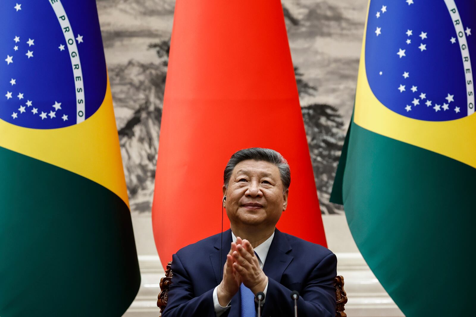 Chinese President Xi Jinping applauds after a a joint press conference with Brazil's President Luiz Inacio Lula da Silva (not pictured) at the Great Hall of the People in Beijing, China, Tuesday, May 13, 2025. (Tingshu Wang/Pool Photo via AP)