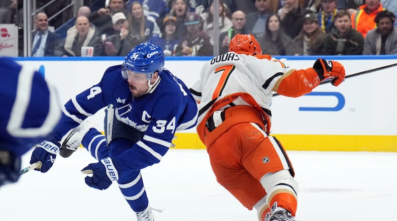 Toronto Maple Leafs Auston Matthews (34) is injured by Anaheim Ducks Radko Gudas (7) during the second period of an NHL hockey game in Toronto, Thursday, March 12, 2026. (Nathan Denette/The Canadian Press via AP)