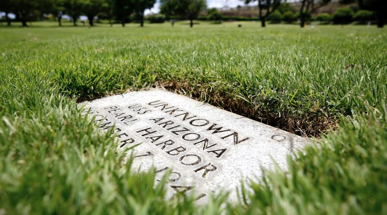 FILE - A grave marker for an unknown casualty from the USS Arizona is shown at the National Memorial Cemetery of the Pacific, July 15, 2021, in Honolulu. (AP Photo/Caleb Jones, File)