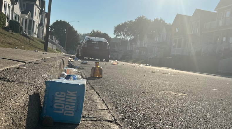 Kiefaber Street near the University of Dayton is strewn with bottles and trash on the morning of Sept. 4, 2023, after a disturbance caused a large police response the night before. JEREMY P. KELLEY / STAFF