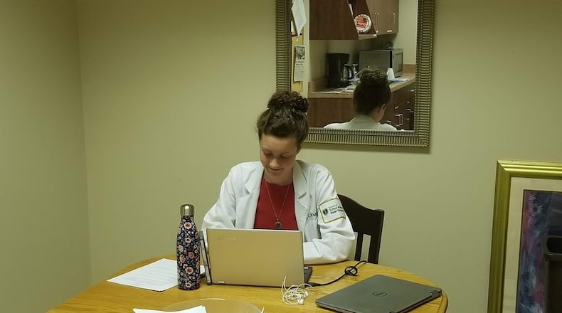 Dr. Lily White, pictured while she was still a student, meeting with patients via telemedicine through the Open Arms Health Clinic. CONTRIBUTED
