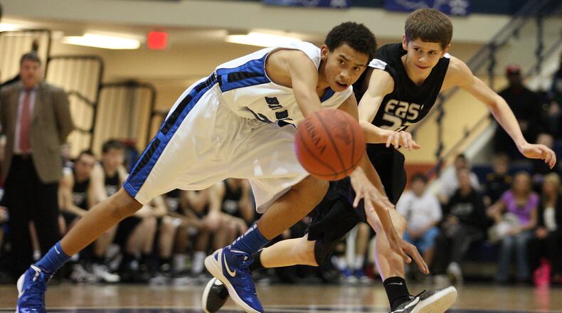 Christian Jones (2) of Hamilton and Dylan Lowry (23) of Lakota East fight for a loose ball on Feb. 3, 2012, at HHS. JOURNAL-NEWS FILE PHOTO