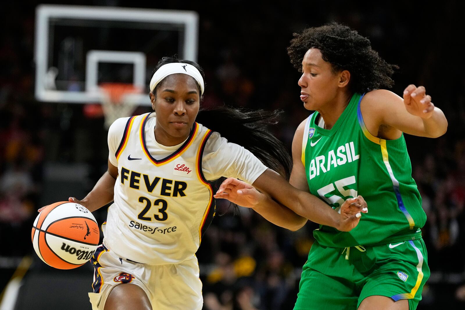 Indiana Fever guard Bree Hall (23) drives to the basket past Brazil forward Taissa Queiroz (55) during the second half of an exhibition women's basketball game, Sunday, May 4, 2025, in Iowa City, Iowa. (AP Photo/Charlie Neibergall)
