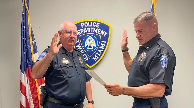 Miami Twp. Police Chief Charles Stiegelmeyer (right) swears in John Magill as the police department's assistant chief. The newly created role and those of two new lieutenant positions are aimed at helping the department increase its efficiency. CONTRIBUTED