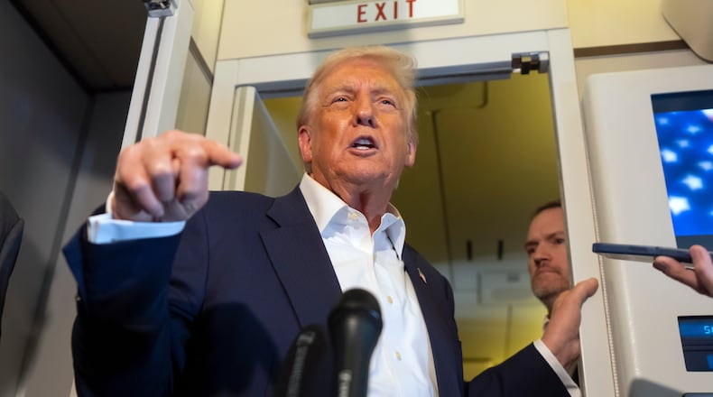 President Donald Trump speaks to reporters aboard Air Force One while traveling from Kuala Lumpur, Malaysia, to Tokyo, Japan, Monday, Oct. 27, 2025. (AP Photo/Mark Schiefelbein)