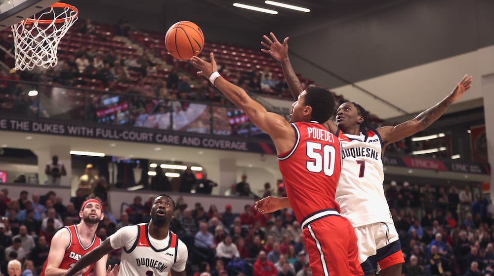 Dayton's Sean Pouedet scores against Duquesne on Tuesday, Jan. 13, 2026, at the UPMC Cooper Fieldhouse in Pittsburgh. David Jablonski/Staff
