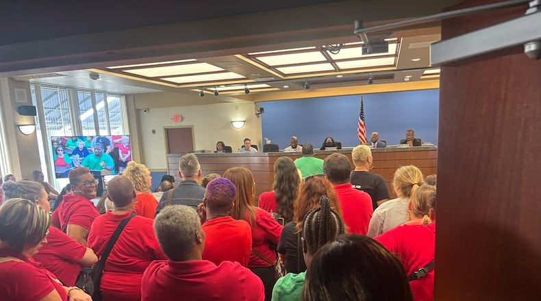 Dayton Public Schools staff crowded into a board room on Wednesday a few days after the district announced a change in pay dates for the 2025-2026 school year. Eileen McClory / staff