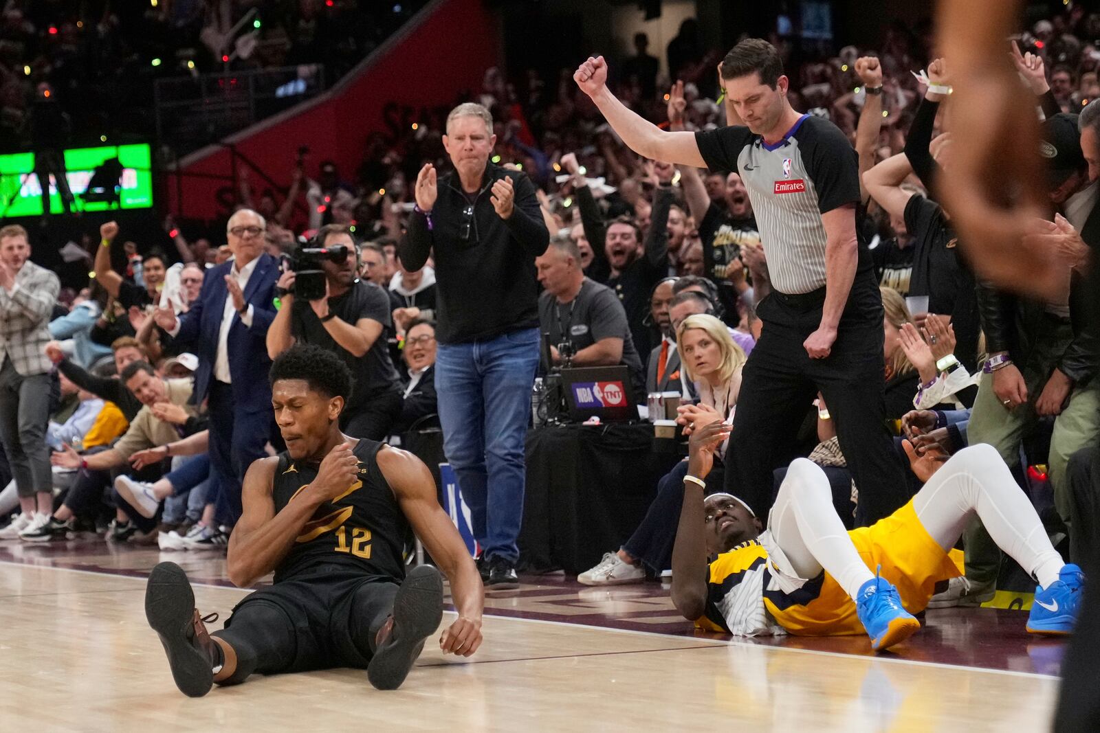 Cleveland Cavaliers forward De'Andre Hunter, left, celebrates after hitting a three-point shot and drawing a foul on Indiana Pacers forward Pascal Siakam, right, during the second half in Game 5 of an Eastern Conference semifinal NBA basketball playoff Tuesday, May 13, 2025, in Cleveland. (AP Photo/Sue Ogrocki)