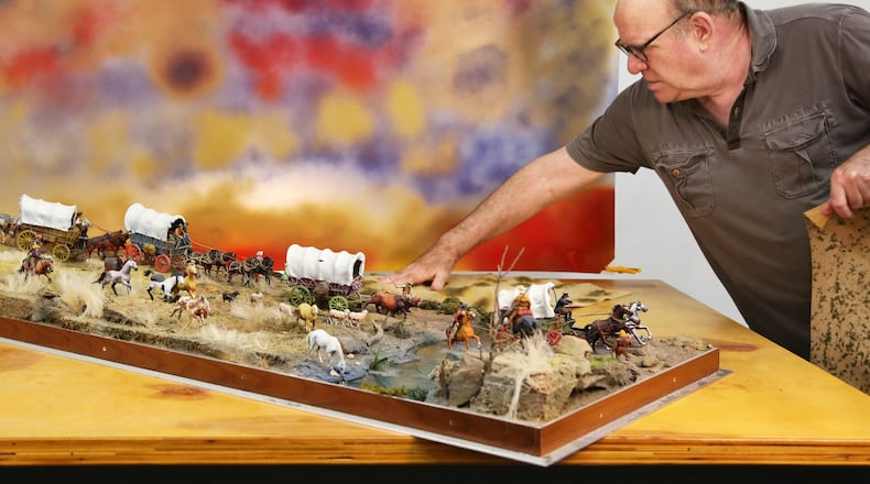 David Levinthal arranges toy figures in his studio for a photo shoot. CONTRIBUTED