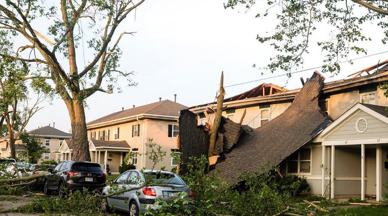 What remains of a roof dangles in front of a home after being taken off by a tornado that damaged approximately 150 homes May 27 in the Properties of Wright-Field at Wright-Patterson Air Force Base. Volunteers from around Wright-Patterson AFB worked alongside base emergency responders and housing residents to ensure everyone’s safety and begin the cleanup process. (U.S. Air Force photo/Wesley Farnsworth)