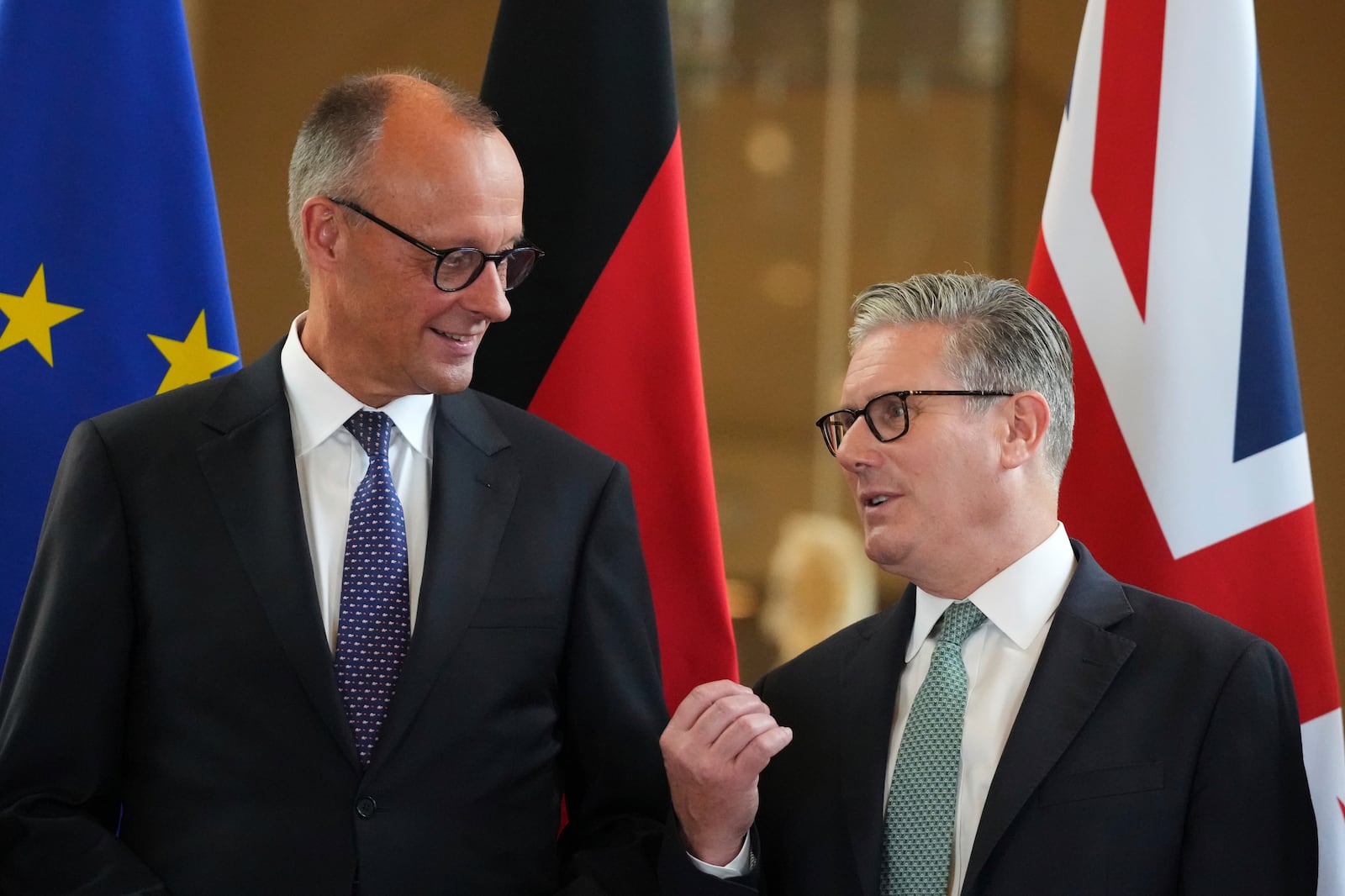Britain's Prime Minister Keir Starmer, right, and German Chancellor Friedrich Merz, left, talk as they attend a signing ceremony of a wide-ranging bilateral cooperation treaty in London, Thursday, July 17, 2025.(AP Photo/Frank Augstein, Pool)
