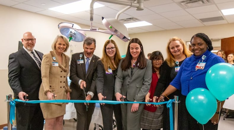 Members of Kettering College faculty, the president of the college, and president of Kettering Health Main Campus cut the ribbon to officially open the simulation lab to students. Photo by Joel Granados, Kettering College Communications Specialist