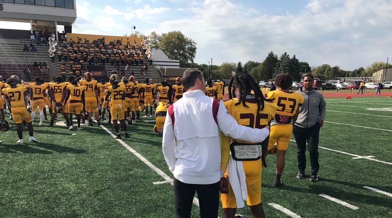 Central State offensive coordinator Buddy Blevins (left) comforts junior wide receiver Micah Lowe after the Marauders' 34-14 loss to Miles. Tom Archdeacon/CONTRIBUTED