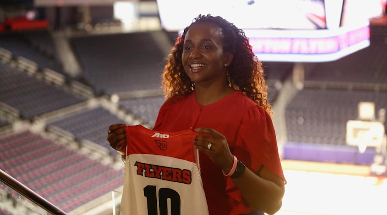 Tamika Williams-Jeter poses for a photo at UD Arena after being introduced as the new Dayton women's basketball coach on Monday, March, 28, 2022. David Jablonski/Staff