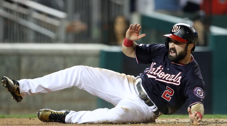 The Nationals' Adam Eaton celebrates as he slides home to score on an RBI double hit by teammate Anthony Rendon in the third inning of game three of the National League Championship Series against the St. Louis Cardinals at Nationals Park on October 14, 2019 in Washington, DC. (Photo by Rob Carr/Getty Images)