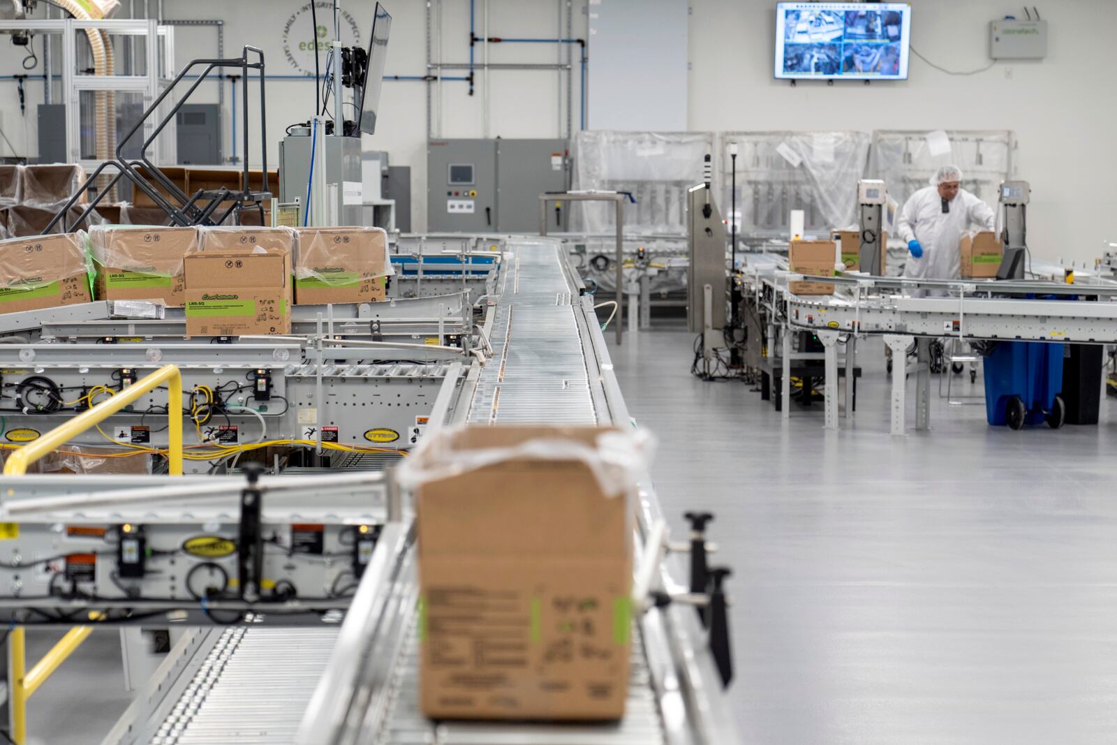 A conveyer belt usually carrying many boxes moves a single box of Plumpy'Nut, a nutritional lifesaving peanut paste sent to malnourished children worldwide, at Edesia Nutrition, Friday, March 14, 2025, in North Kingstown, R.I. (AP Photo/David Goldman)
