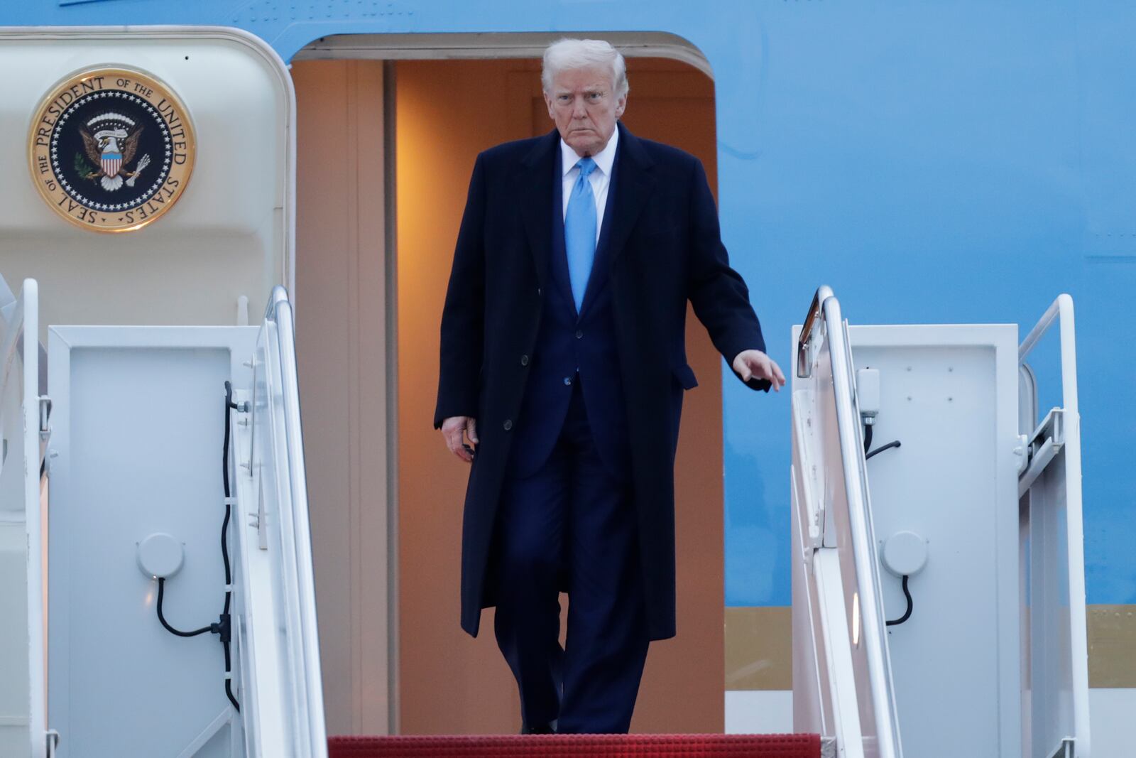 President Donald Trump walks down the stairs of Air Force One upon his arrival at Joint Base Andrews, Md., Sunday, April 6, 2025. (AP Photo/Luis M. Alvarez)