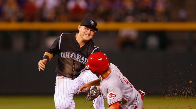 DENVER, CO - JULY 5:  Pat Valaika #4 of the Colorado Rockies applies the tag to catch Jose Peraza #9 of the Cincinnati Reds in an attempt to steal second base to end the eighth inning at Coors Field on July 5, 2017 in Denver, Colorado. The Rockies defeated the Reds 5-3. (Photo by Justin Edmonds/Getty Images)
