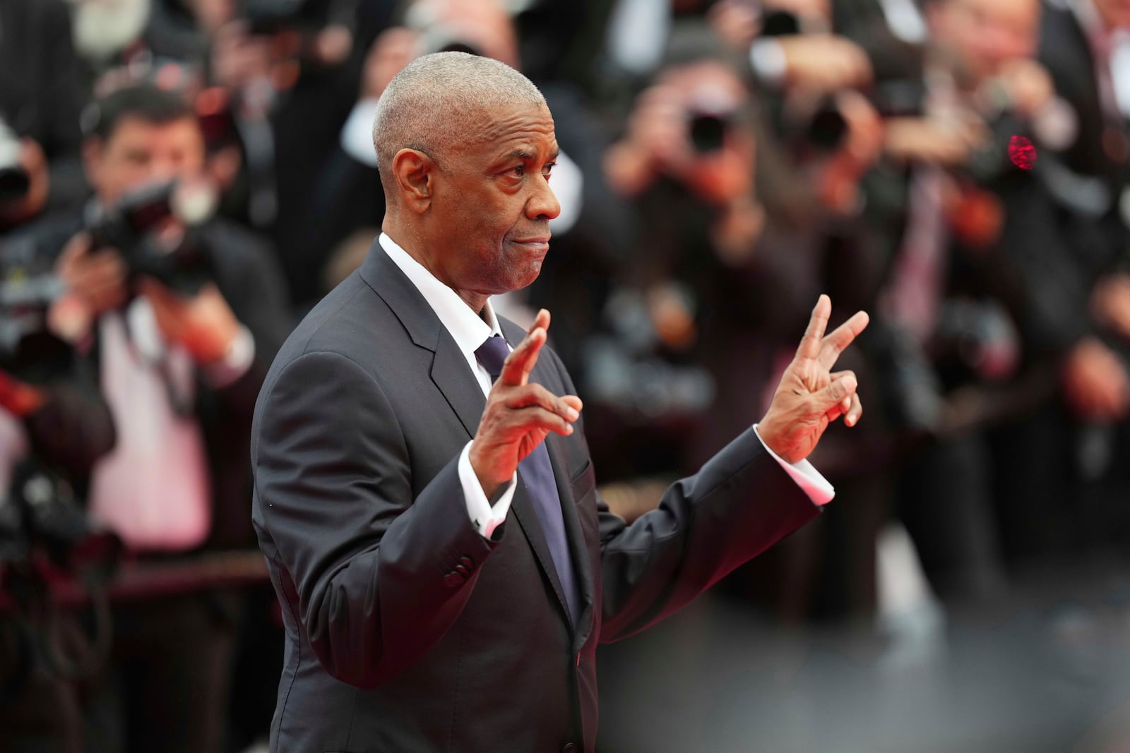 Denzel Washington poses for photographers upon arrival at the premiere of the film 'Highest 2 Lowest' at the 78th international film festival, Cannes, southern France, Monday, May 19, 2025. (Photo by Lewis Joly/Invision/AP)