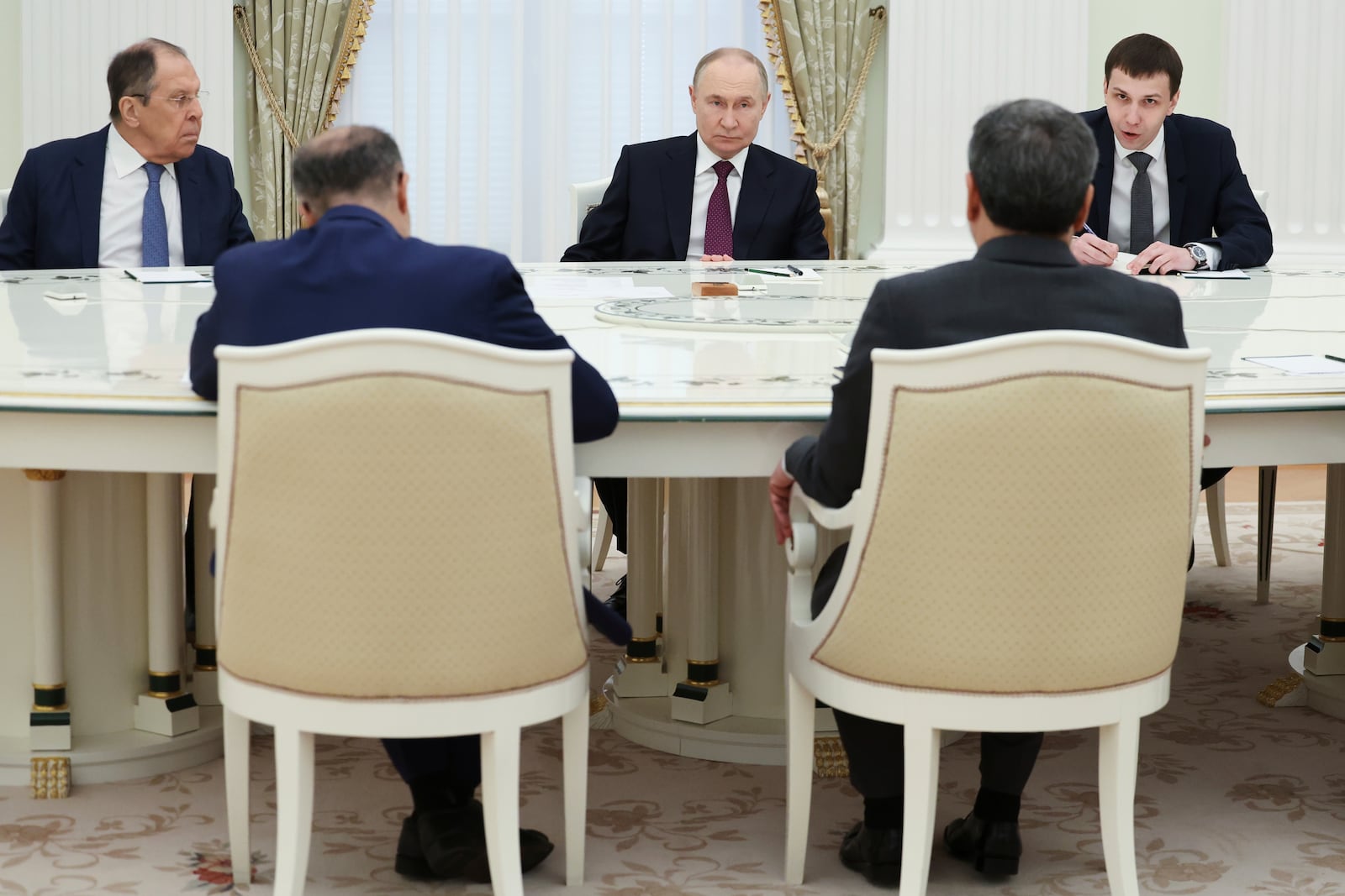 Russian President Vladimir Putin, center, listens to Iranian Foreign Minister Abbas Araghchi, right back to a camera, during their talks at the Kremlin in Moscow, Russia, Monday, June 23, 2025. (Alexander Kazakov, Sputnik, Kremlin Pool Photo via AP)
