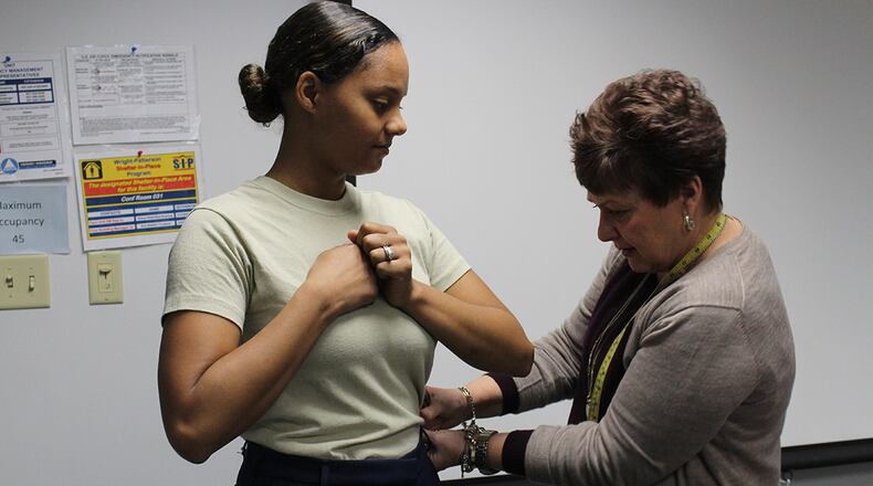 Tracy Roan, Air Force Uniform Office chief, measures Airman 1st Class Madison Gilbert, an administrative technician in the Air Force Life Cycle Management Center Director of Staff’s office, to see if she fits the measurements to try on the sample pair of the newly designed female slacks. As part of the prototype development phase, the technical team conducts fit evaluations to determine what modifications need to be made to achieve a final prototype (U.S. Air Force photos/Stacey Geiger)