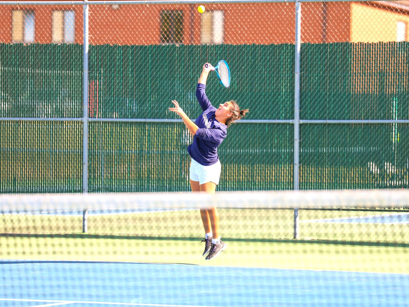Diana Ivanikhina – the No. 1 singles player on the Cedarville University tennis team who has won both All-G-MAC tennis honors and G-MAC All Academic honors – in action for the Yellow Jackets. She has one the of the most incredible hardship-to-glory stories in college sports. MEGAN STRUNK / CEDARVILLE UNIVERSITY