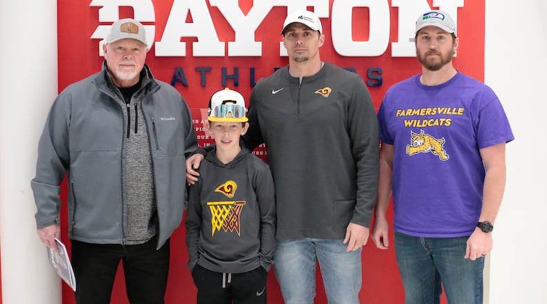 The Buehner family - from left to right, Ted Buehner, JJ Buehner, Ben Buehner and Teddy Buehner - has made attending the annual state boys basketball tournament family tradition. They're seen here at UD Arena on on Friday, March 17, 2023. CONTRIBUTED BY MICHAEL COOPER