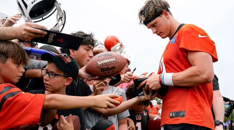 Cincinnati Bengals quarterback Joe Burrow signs autographs during the NFL football team's training camp, Wednesday, July 26, 2023, in Cincinnati. (AP Photo/Jeff Dean)