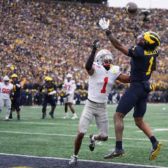 Michigan wide receiver Donaven McCulley, right, is unable to catch a pass against Ohio State Buckeyes cornerback Davison Igbinosun during the first half of an NCAA college football game, Saturday, Nov. 29, 2025, in Ann Arbor, Mich. (AP Photo/Ryan Sun)