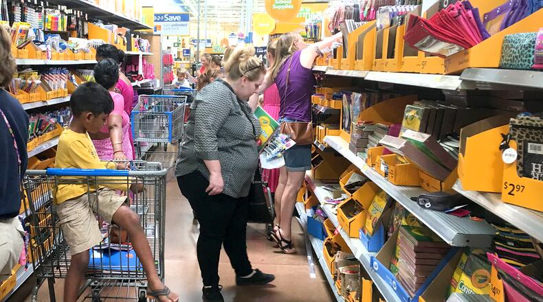 Two area Republican state legislators are proposing a bill that would prohibit county commissioners from increasing sales taxes without approval at the ballot box by registered voters. Here, Walmart shoppers are seen in Miami Twp. KARA DRISCOLL / STAFF