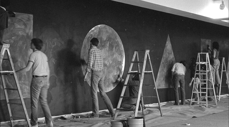 Artists are pictured working on the original Sol LeWitt drawing at Wright State University in 1981. The drawings will be re-installed in February. They will demonstrate how the same idea can be executed in different ways. SUBMITTED PHOTO FROM LEWITT ARCHIVES