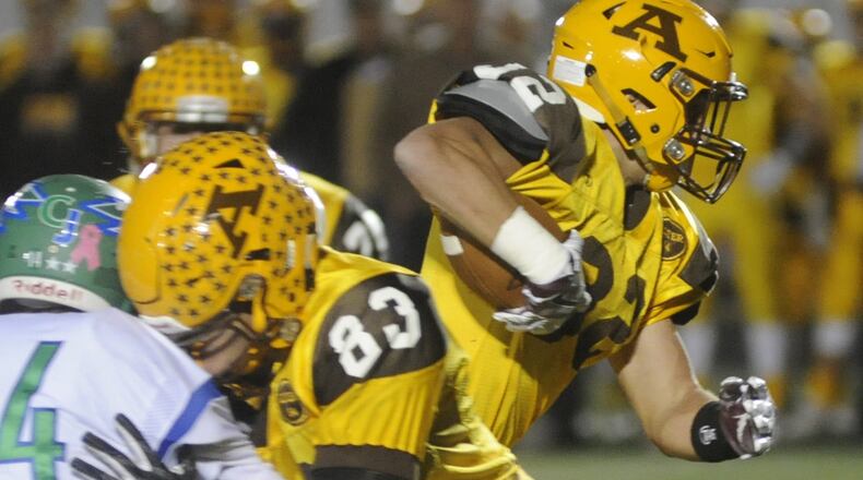 Alter running back Holden Rushing (right) gets a heads-up block from teammate Jack Mochty (83). Alter defeated Chaminade Julienne 51-3 at Springboro in a Week 10 high school football game on Friday, Oct. 28, 2016. MARC PENDLETON / STAFF
