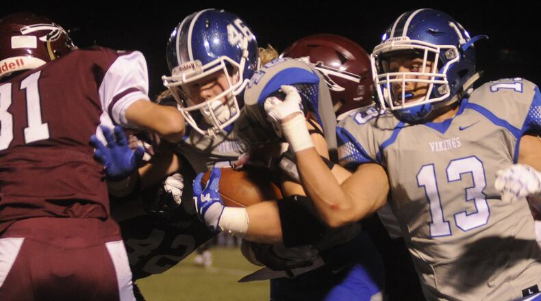 Miamisburg senior RB Jake Neatherton (with ball) is assisted by teammate Tyler Johnson. Lebanon hosted Miamisburg in a GWOC National West high school football game on Friday, Oct. 14, 2016. MARC PENDLETON / STAFF
