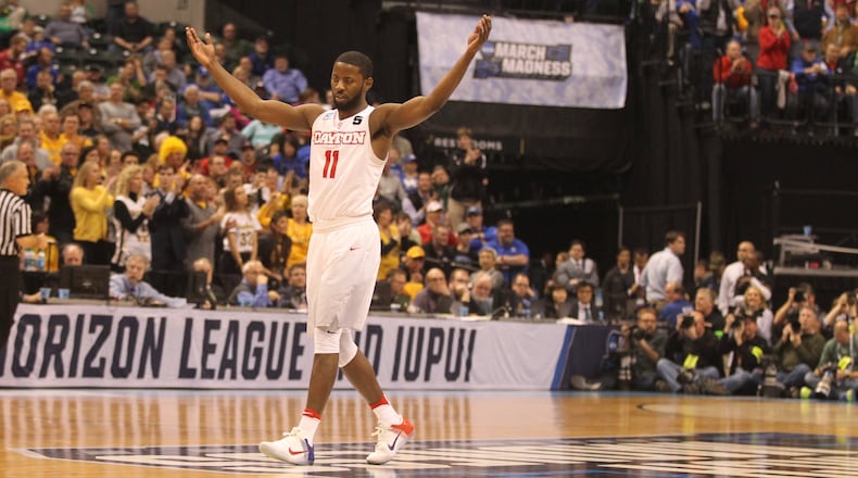 Dayton's Scoochie Smith raises his arms in the second half to pump up the crowd during a game against Wichita State in the first round of the NCAA tournament on Friday, March 17, 2017, at Bankers Life Fieldhouse in Indianapolis.