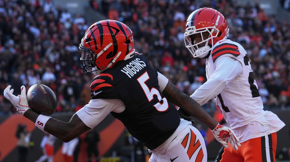 Cincinnati Bengals wide receiver Tee Higgins (5) catches a touchdown pass against Cleveland Browns cornerback Sam Webb during the first half of an NFL football game, Sunday, Jan. 4, 2026, in Cincinnati. (AP Photo/Jeff Dean)