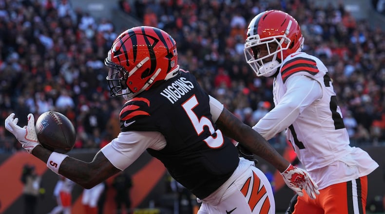 Cincinnati Bengals wide receiver Tee Higgins (5) catches a touchdown pass against Cleveland Browns cornerback Sam Webb during the first half of an NFL football game, Sunday, Jan. 4, 2026, in Cincinnati. (AP Photo/Jeff Dean)
