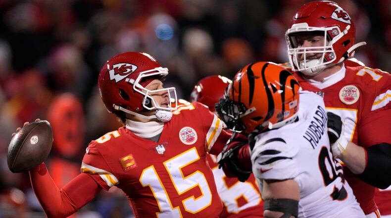 Kansas City Chiefs quarterback Patrick Mahomes (15) passes under pressure from the Cincinnati Bengals during the second half of the NFL AFC Championship playoff football game, Sunday, Jan. 29, 2023, in Kansas City, Mo. (AP Photo/Jeff Roberson)