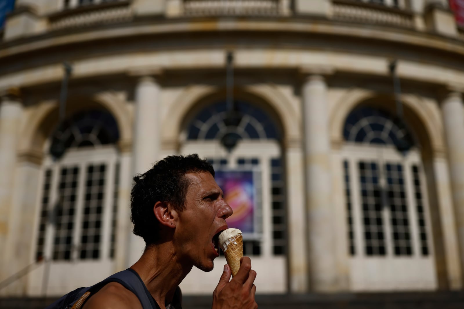 A man eats an ice cream during a heat wave, Tuesday, July 1, 2025 in Rennes, western France. (AP Photo/Jeremias Gonzalez)