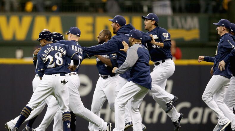 MILWAUKEE, WI - OCTOBER 04: The Milwaukee Brewers celebrate winning Game One of the National League Division Series game 3-2 over the Colorado Rockies after Mike Moustakas #18 hits a a walk off single at Miller Park on October 4, 2018 in Milwaukee, Wisconsin. (Photo by Dylan Buell/Getty Images)